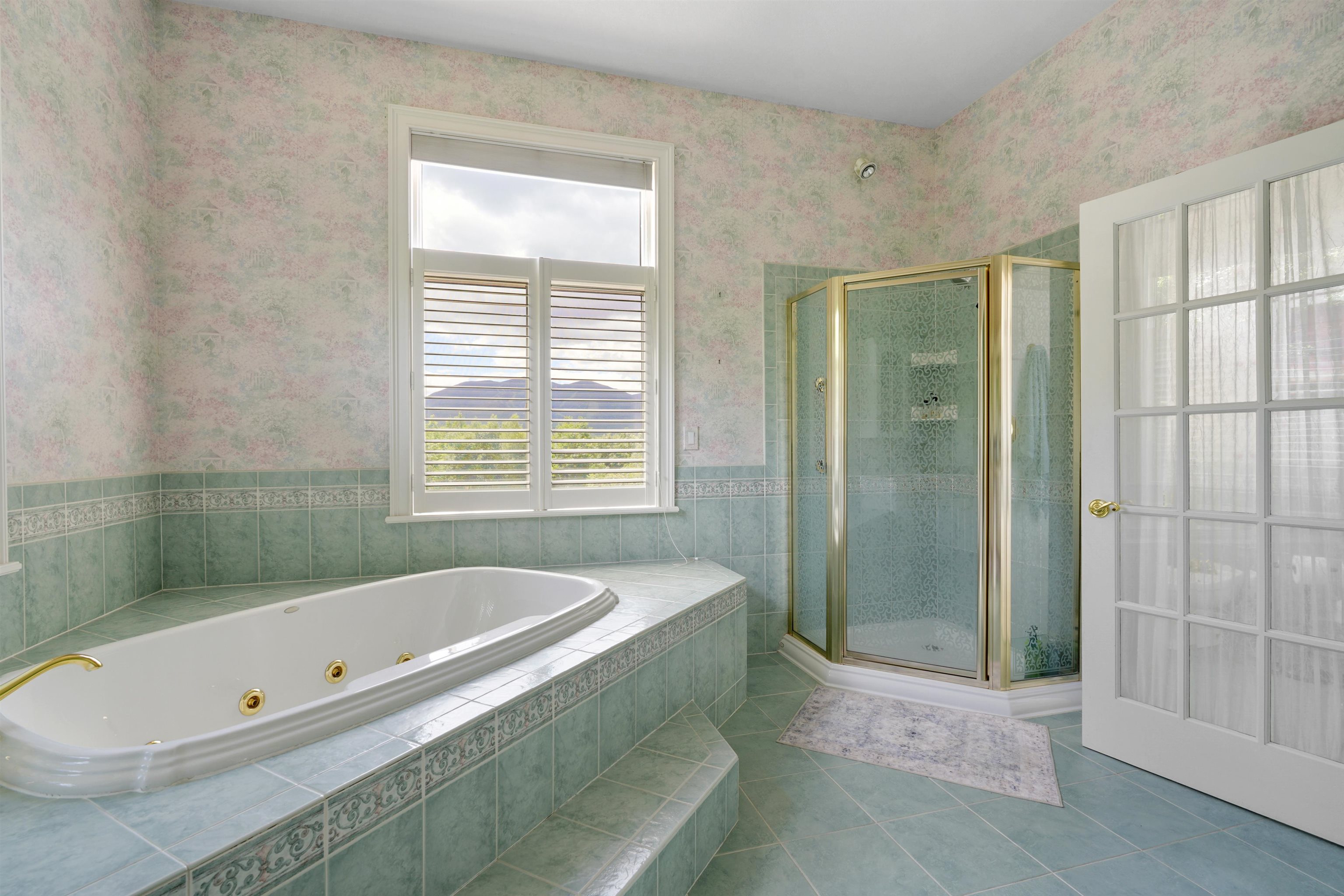 jetted tub and shower in primary suite