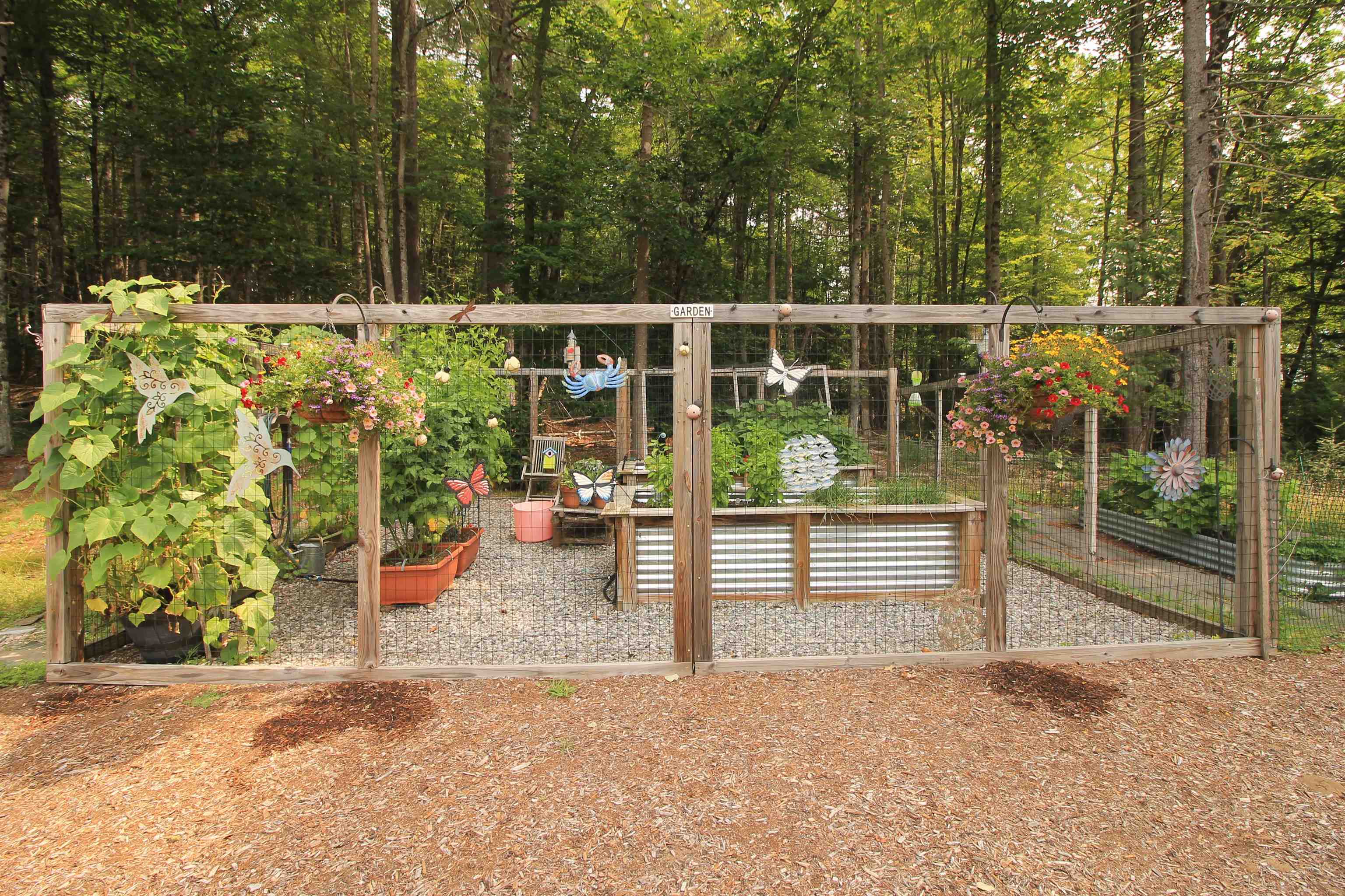 Beautiful fenced in raised bed garden area.