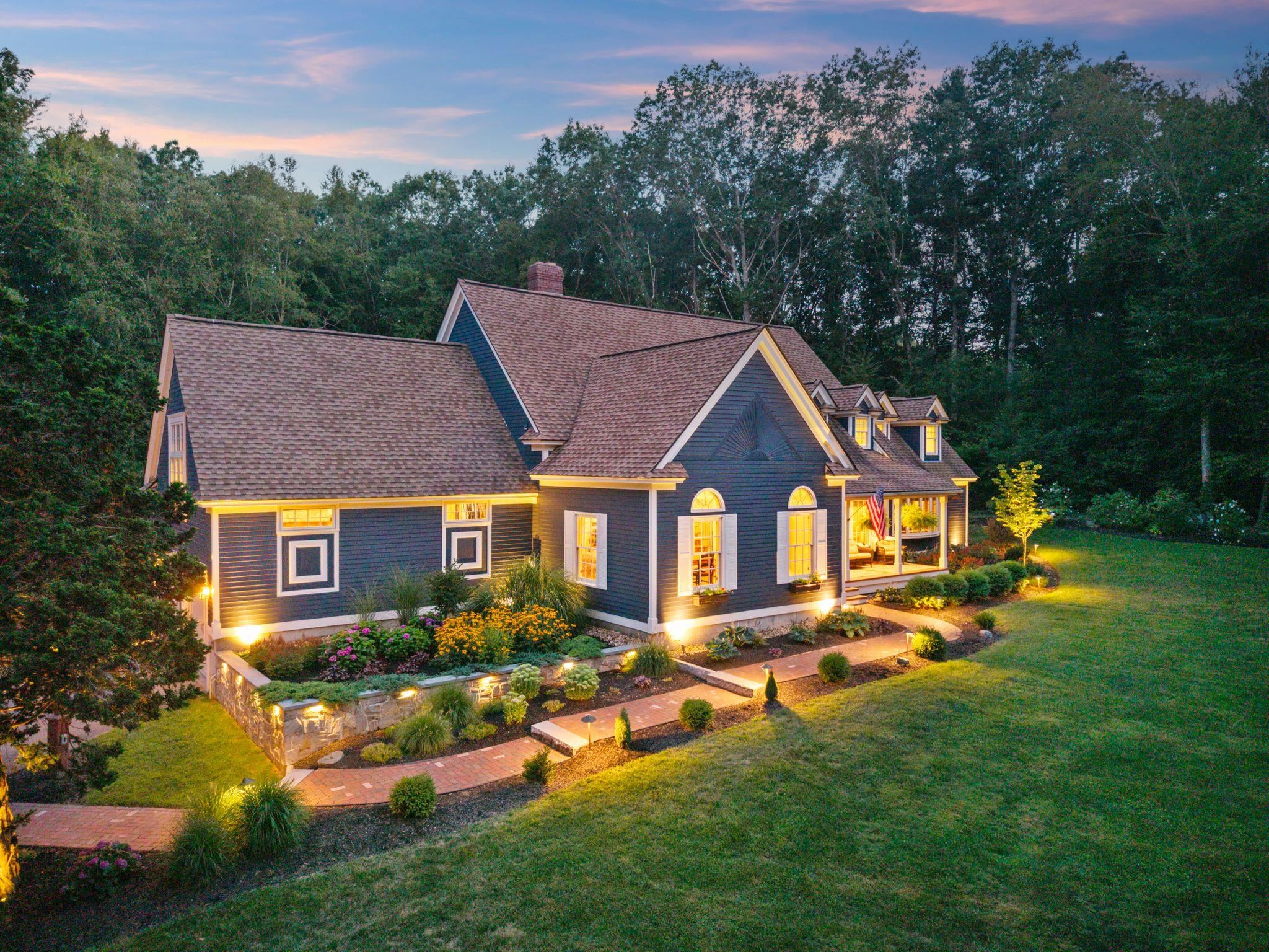 Situated in a beautiful cul-de-sac neighborhood is this impeccable cape style home on just over 2 private acres.From the moment you approach this home you will understand just how special it is.Having been thoughtfully cared for & exquisitely updated over the years, it is truly one of a kind on the Seacoast.  With breathtaking curb appeal, stunning grounds & interior detail throughout it is an honor to call this "home".The back yard is a dreamy oasis w/ an expansive blue stone patio, stone walls, tiered entertaining spaces w/ relaxing fire pit to gather, state of the art hot tub lit w/ bistro lights; there is no shortage of impeccable taste that went into the landscape.Step inside after having relaxed on the front farmers porch enjoying the lush professional landscape & you are greeted w/ incredible taste. The open concept floor plan boasts rich amenities & utility throughout.The lower level boasts a large front to back living/dining space w/ new gas fireplace & lit built ins, a large daylit eat in kitchen w/ high end stainless appliances & relaxing seating area to watch tv as you cook & entertain.The bonus is the large space that could be used as a family room or space for guests to sleep w/ murphy bed & attached bath all on the 1st floor.Upstairs are 4 bedrooms including a gorgeous Primary w/ 2 offices & laundry w/ multiple walk-ins.And the finished basement has a workout room and family room.  So many updates & upgrades! Great commuter location to 95, 101 & the NH beaches.