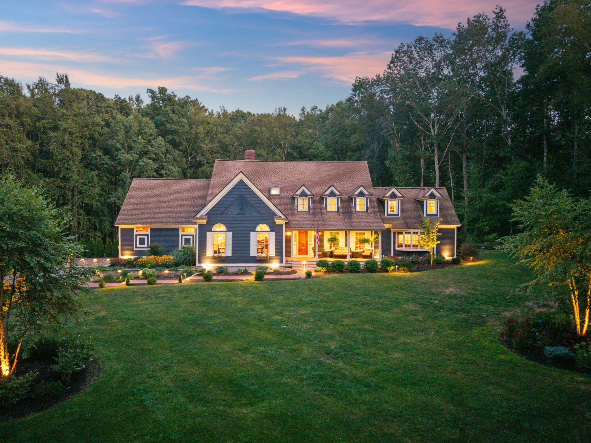 Situated in a beautiful cul-de-sac neighborhood is this impeccable cape style home on just over 2 private acres.From the moment you approach this home you will understand just how special it is.Having been thoughtfully cared for & exquisitely updated over the years, it is truly one of a kind on the Seacoast.  With breathtaking curb appeal, stunning grounds & interior detail throughout it is an honor to call this "home".The back yard is a dreamy oasis w/ an expansive blue stone patio, stone walls, tiered entertaining spaces w/ relaxing fire pit to gather, state of the art hot tub lit w/ bistro lights; there is no shortage of impeccable taste that went into the landscape.Step inside after having relaxed on the front farmers porch enjoying the lush professional landscape & you are greeted w/ incredible taste. The open concept floor plan boasts rich amenities & utility throughout.The lower level boasts a large front to back living/dining space w/ new gas fireplace & lit built ins, a large daylit eat in kitchen w/ high end stainless appliances & relaxing seating area to watch tv as you cook & entertain.The bonus is the large space that could be used as a family room or space for guests to sleep w/ murphy bed & attached bath all on the 1st floor.Upstairs are 4 bedrooms including a gorgeous Primary w/ 2 offices & laundry w/ multiple walk-ins.And the finished basement has a workout room and family room.  So many updates & upgrades! Great commuter location to 95, 101 & the NH beaches.