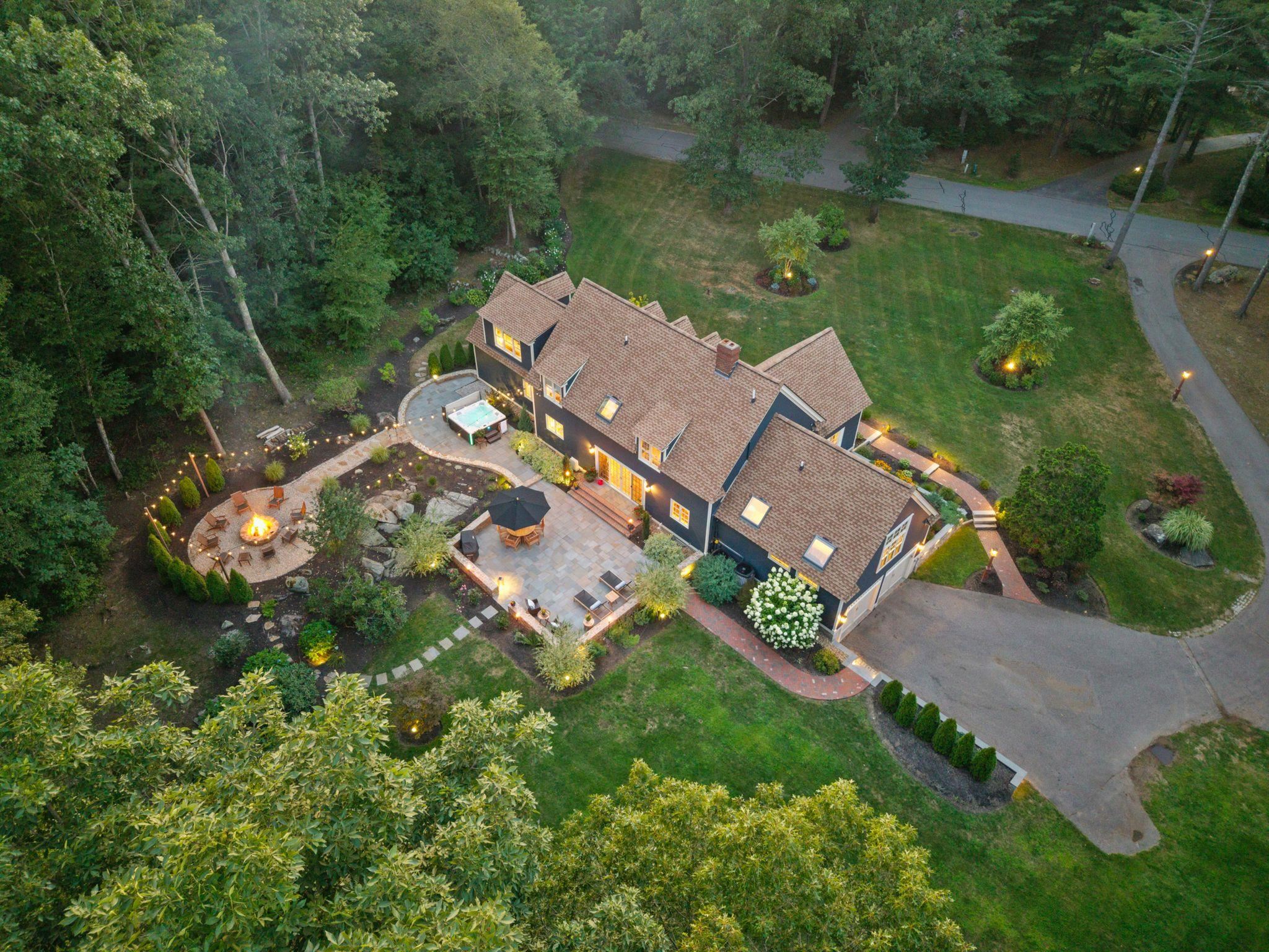 Situated in a beautiful cul-de-sac neighborhood is this impeccable cape style home on just over 2 private acres.From the moment you approach this home you will understand just how special it is.Having been thoughtfully cared for & exquisitely updated over the years, it is truly one of a kind on the Seacoast.  With breathtaking curb appeal, stunning grounds & interior detail throughout it is an honor to call this "home".The back yard is a dreamy oasis w/ an expansive blue stone patio, stone walls, tiered entertaining spaces w/ relaxing fire pit to gather, state of the art hot tub lit w/ bistro lights; there is no shortage of impeccable taste that went into the landscape.Step inside after having relaxed on the front farmers porch enjoying the lush professional landscape & you are greeted w/ incredible taste. The open concept floor plan boasts rich amenities & utility throughout.The lower level boasts a large front to back living/dining space w/ new gas fireplace & lit built ins, a large daylit eat in kitchen w/ high end stainless appliances & relaxing seating area to watch tv as you cook & entertain.The bonus is the large space that could be used as a family room or space for guests to sleep w/ murphy bed & attached bath all on the 1st floor.Upstairs are 4 bedrooms including a gorgeous Primary w/ 2 offices & laundry w/ multiple walk-ins.And the finished basement has a workout room and family room.  So many updates & upgrades!  SHOWINGS BEGIN AT OPENS 8/15 4-6, 8/16 & 8/17 11-1.