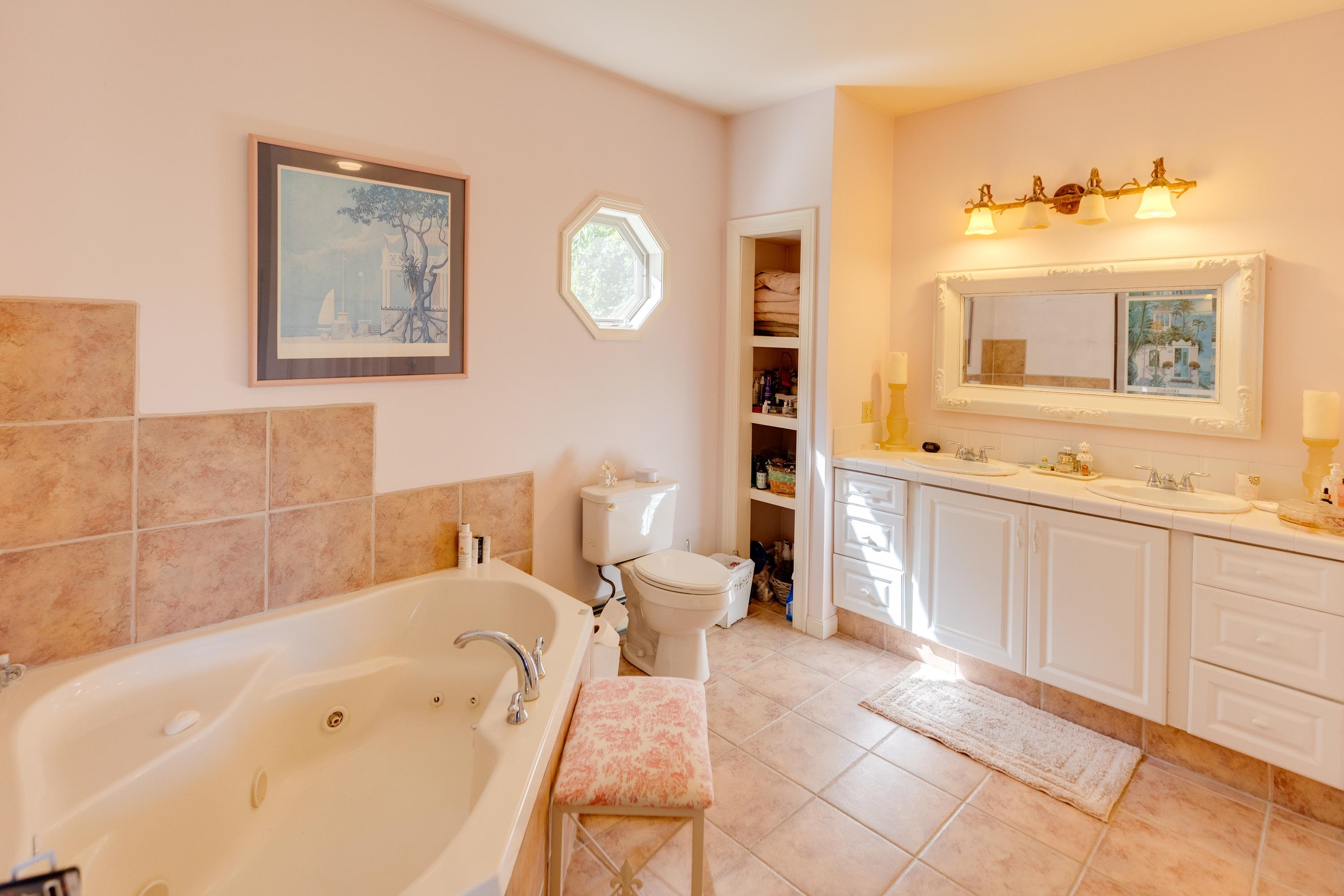 primary ensuite bath with jacuzzi tub and shower