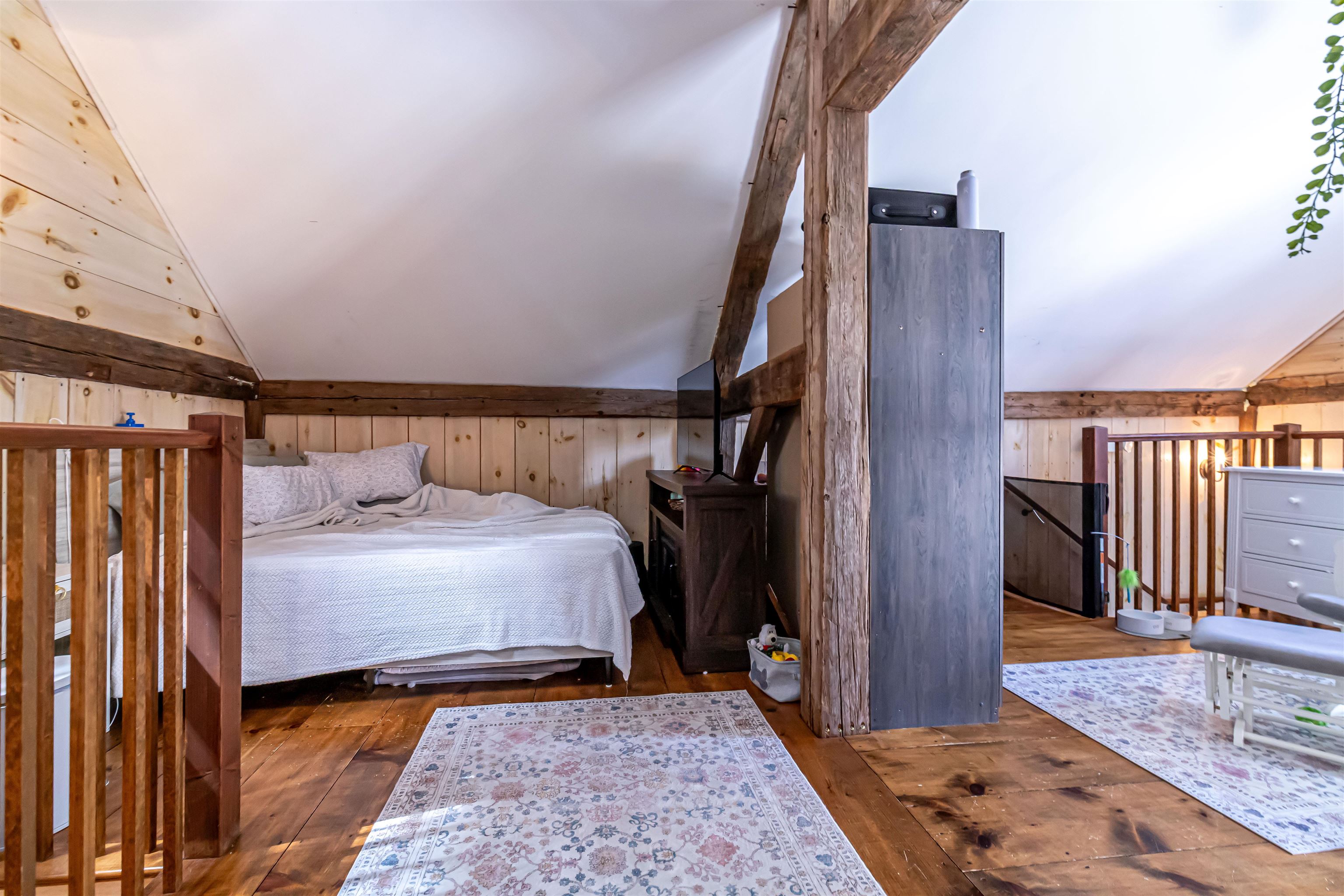 Upstairs at the carriage house is a lofted space Bedrrom