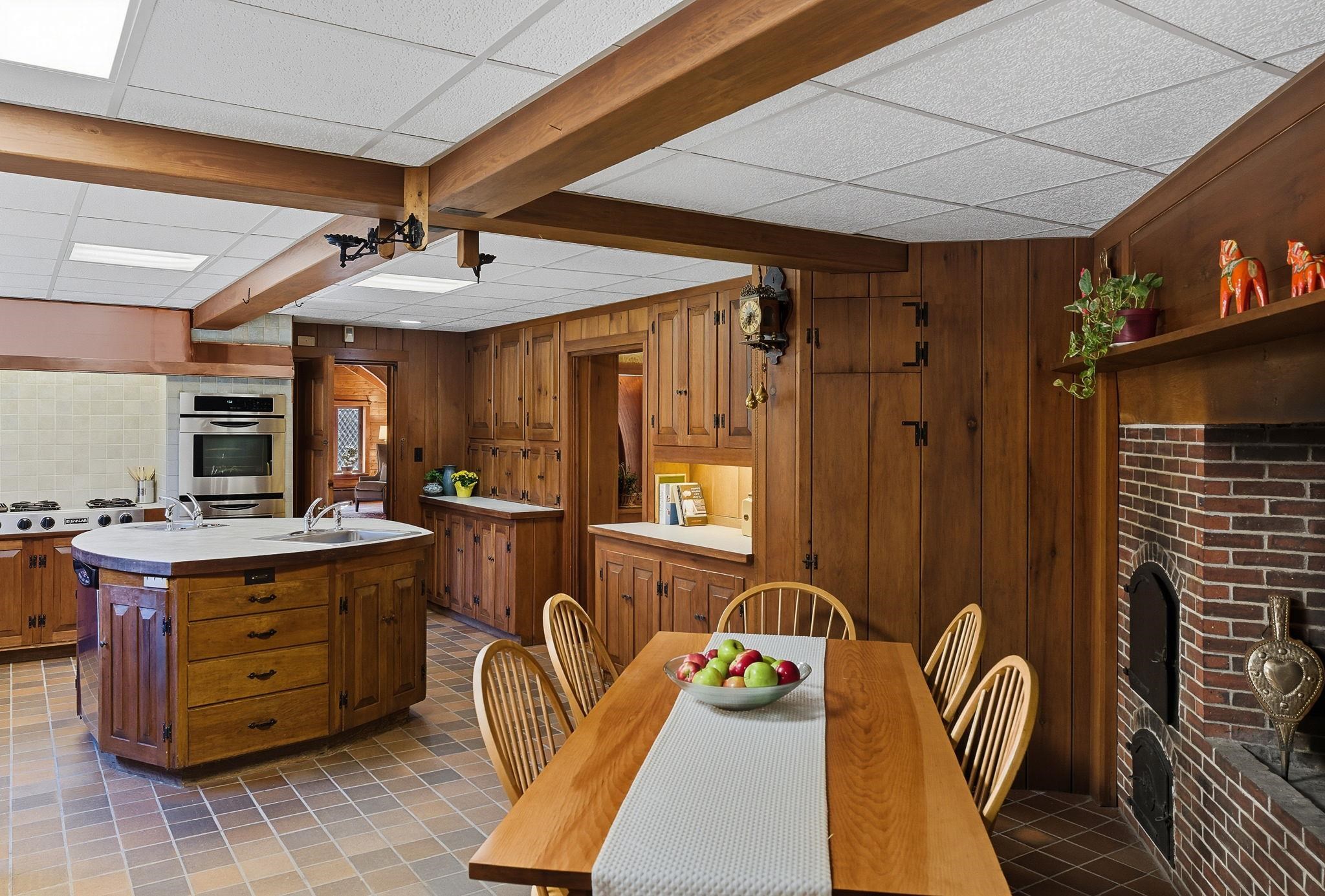 Kitchen with Beamed Ceiling and Raised Hearth Fireplace