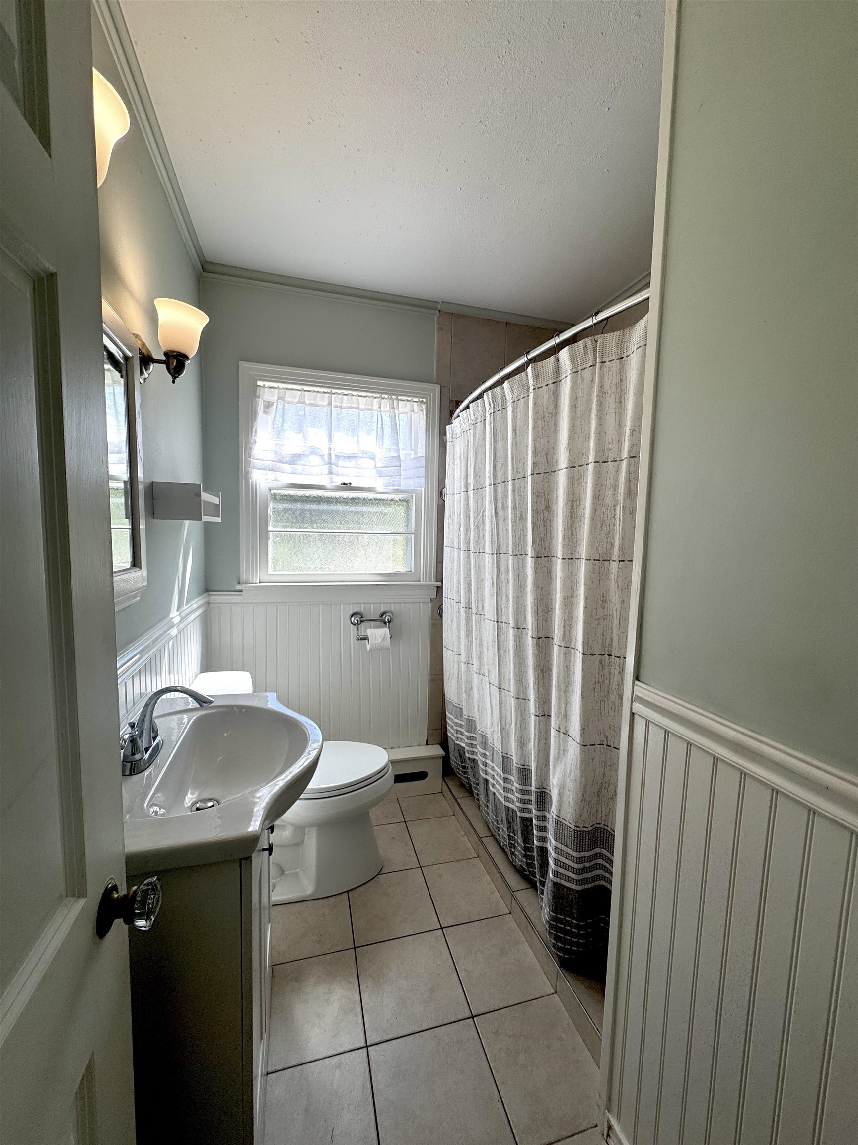 Downstairs bathroom with tiled flooring for easy upkeep