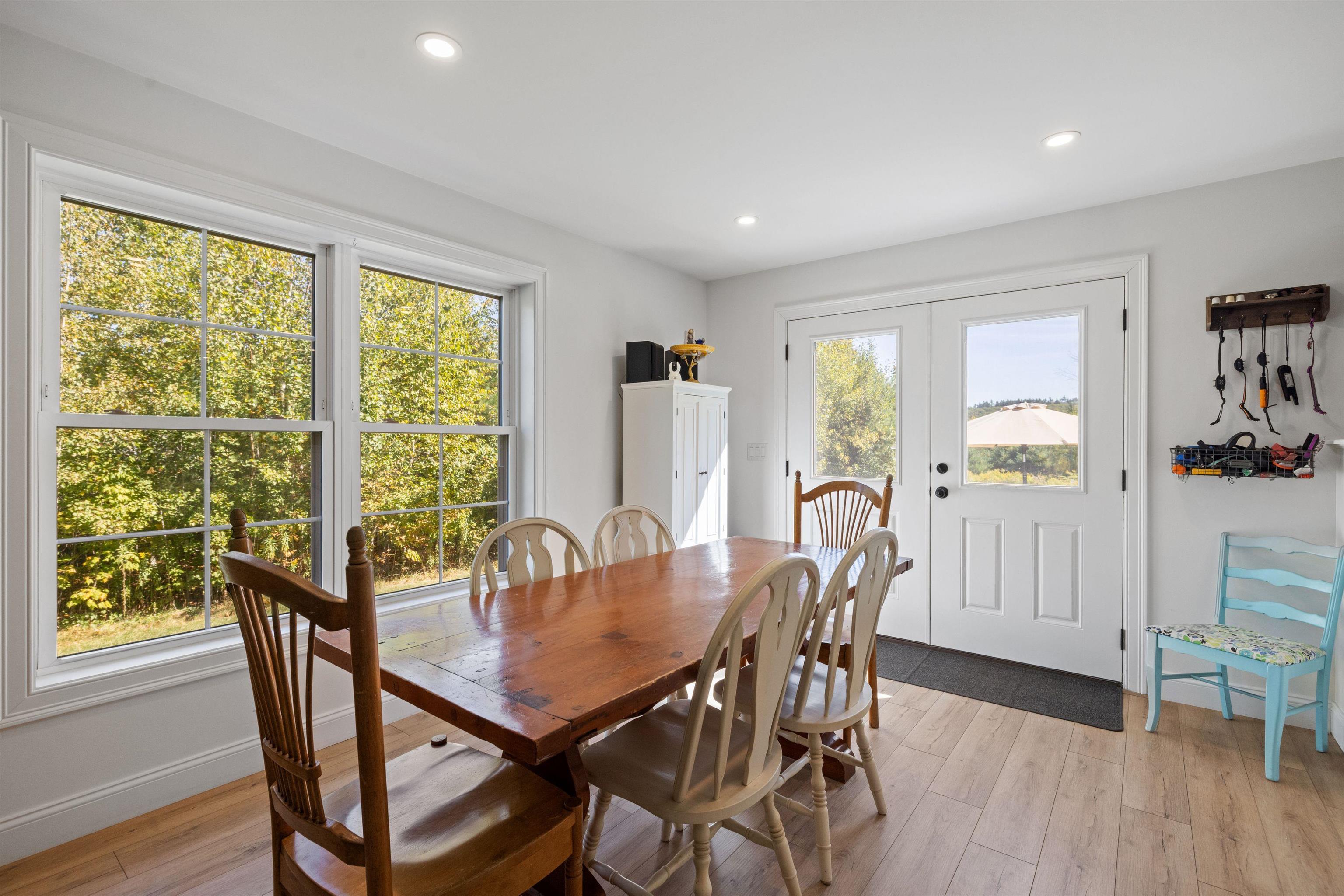 french doors lead out of dining area to backyard patio