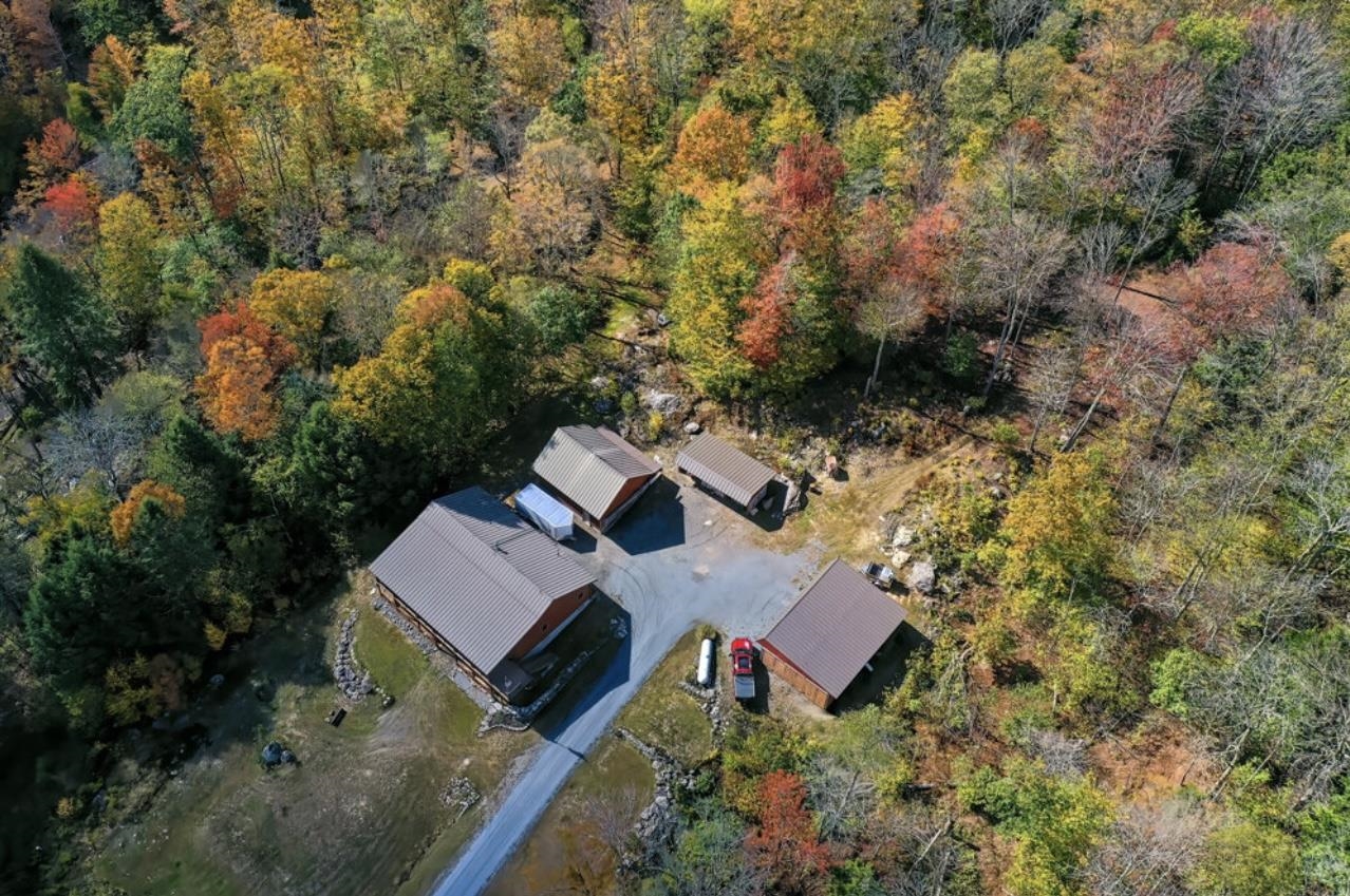 Aerial view of the Log Home, Garage, Woodshed, and 4 Bay Pole Barn 24182982