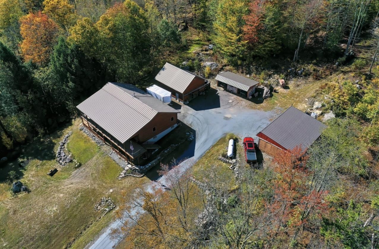 Aerial view of the Log Home, Garage, Woodshed, and 4 Bay Pole Barn 24182983