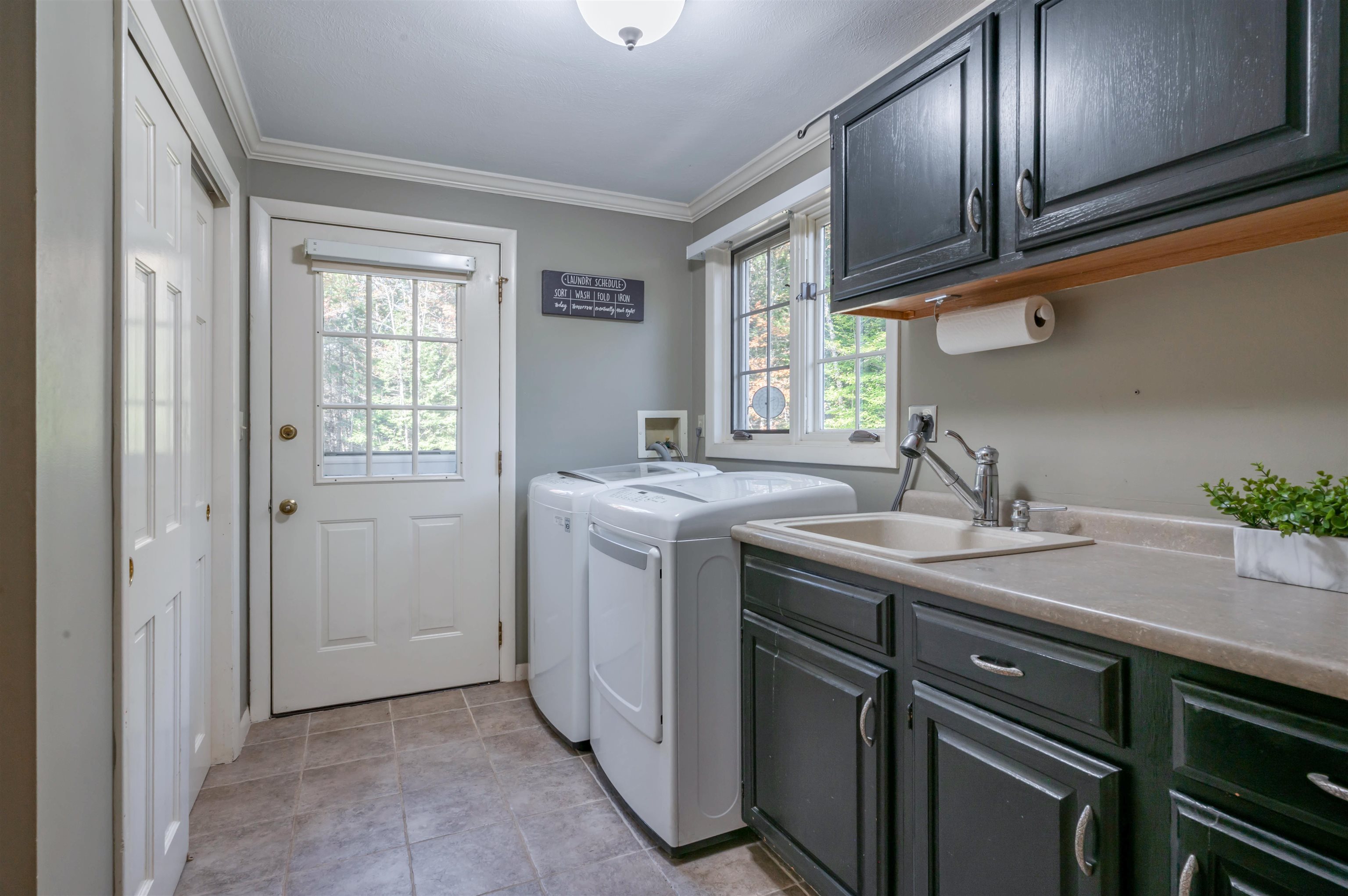 Laundry room off kitchen with utility sink & storage!