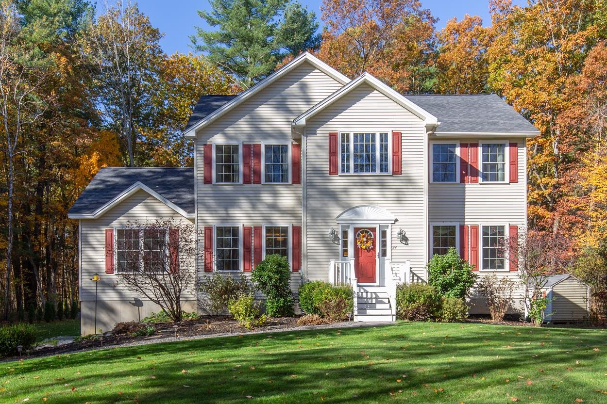 Set back from the road on a private, picturesque lot, this stunning Colonial offers the perfect blend of timeless charm and modern comfort. The home welcomes you with gorgeous curb appeal and continues to impress inside with gleaming hardwood floors throughout and a freshly painted interior. The bright and open layout features a spacious family room with a cozy gas fireplace, a well-appointed kitchen, and a dining area that flows seamlessly into the sunroom addition—a perfect spot to relax year-round. Step outside to enjoy the large custom composite deck overlooking a peaceful, private backyard framed by a classic stone wall—ideal for entertaining or unwinding in nature. Upstairs, the primary suite offers a tranquil retreat complete with a soaking tub and ample closet space. Two additional bedrooms and an open loft area overlooks the soaring entryway. The finished basement adds even more versatility with custom cabinetry and a dedicated home gym. A standby generator offers peace of mind and convenience. With over 2.5 acres of land, beautiful outdoor spaces, and a thoughtfully designed interior, this home truly has it all—comfort, privacy, and style.