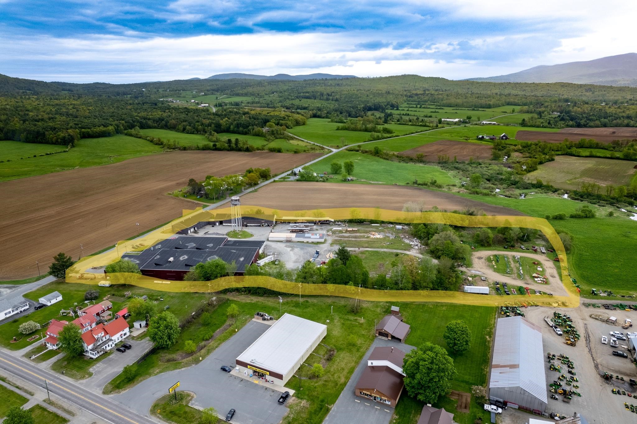 Aerial view showing lot outlined; room for further development