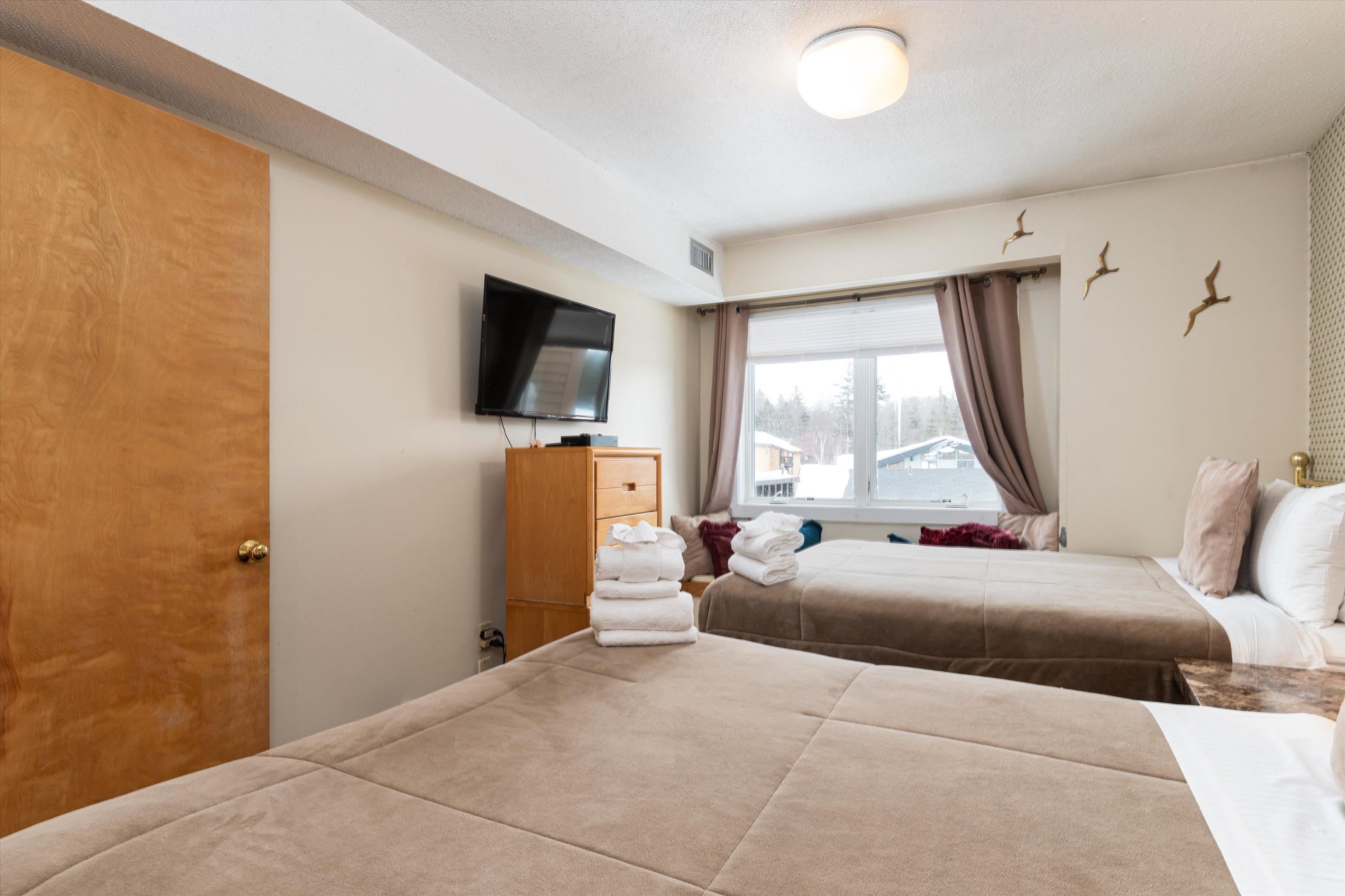 Oversized bedroom comfortably handles two double beds 22769460