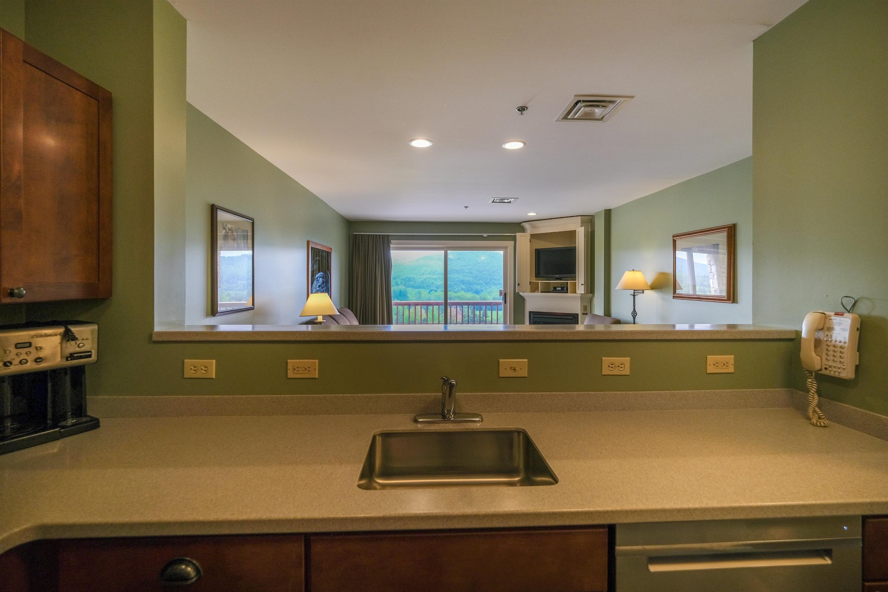 Kitchen sink overlooks living space 23412868