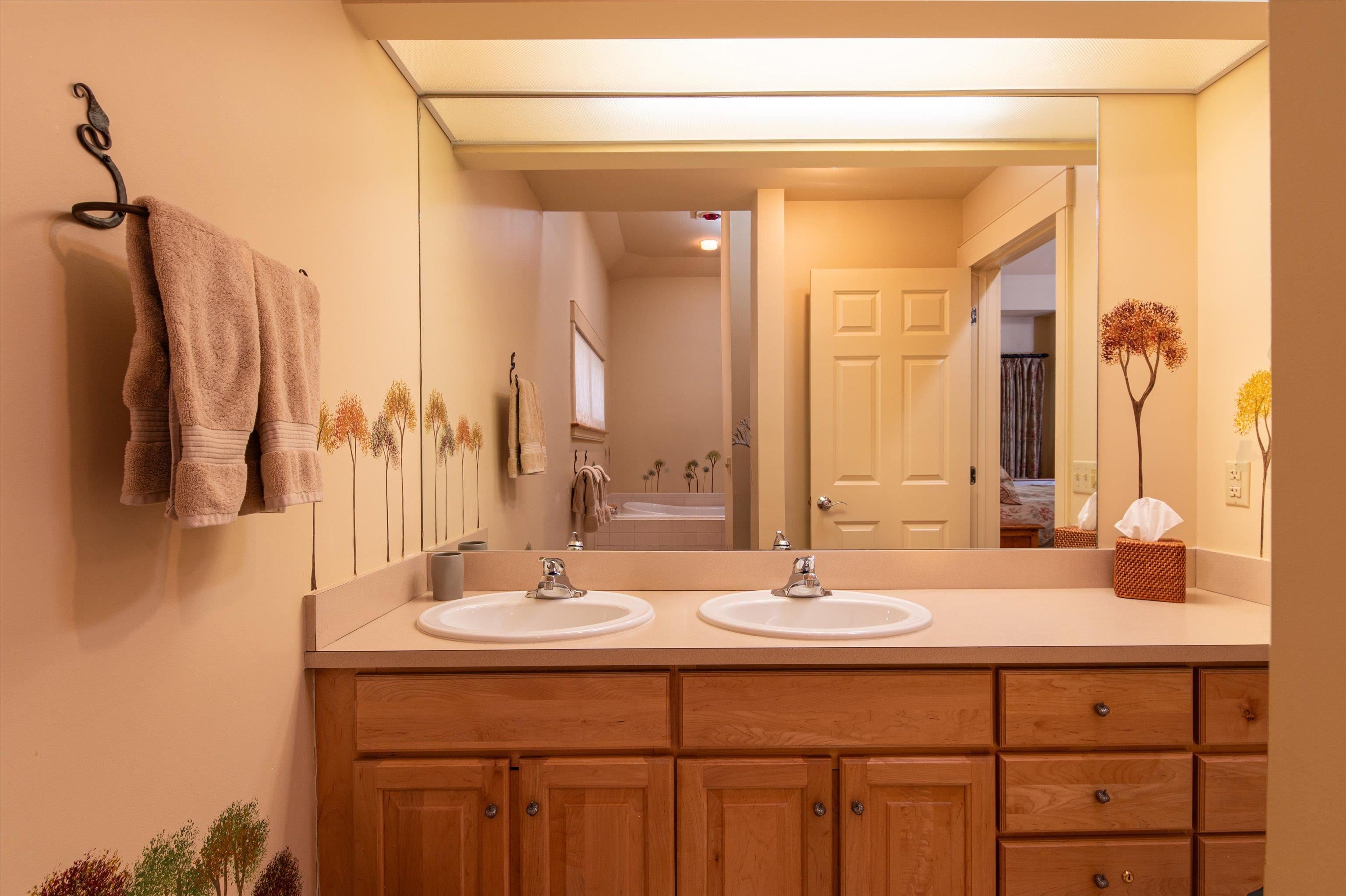 Subtle treescape art in primary bathroom 23533983