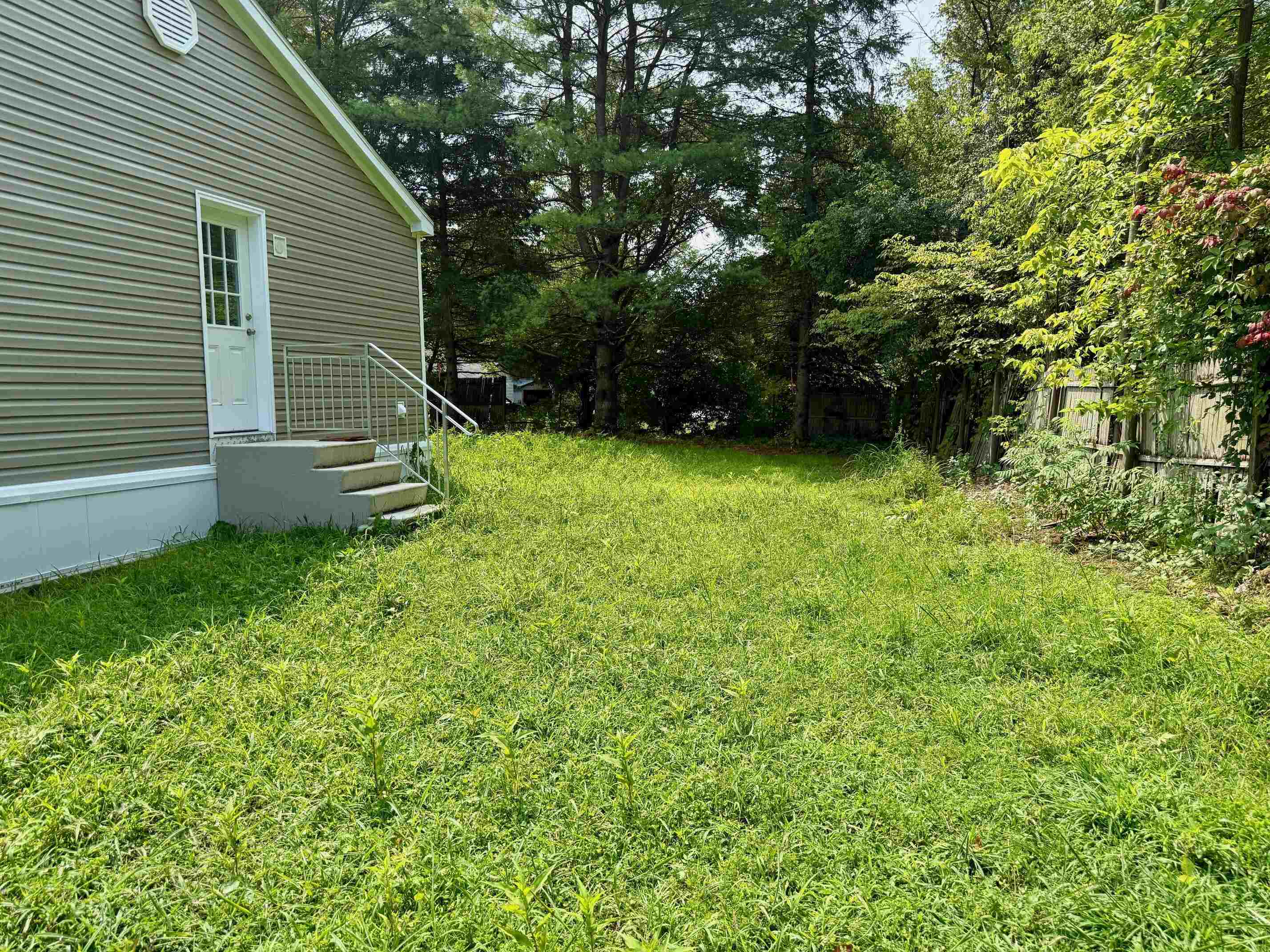 Side door and yard, room for a carport or garage