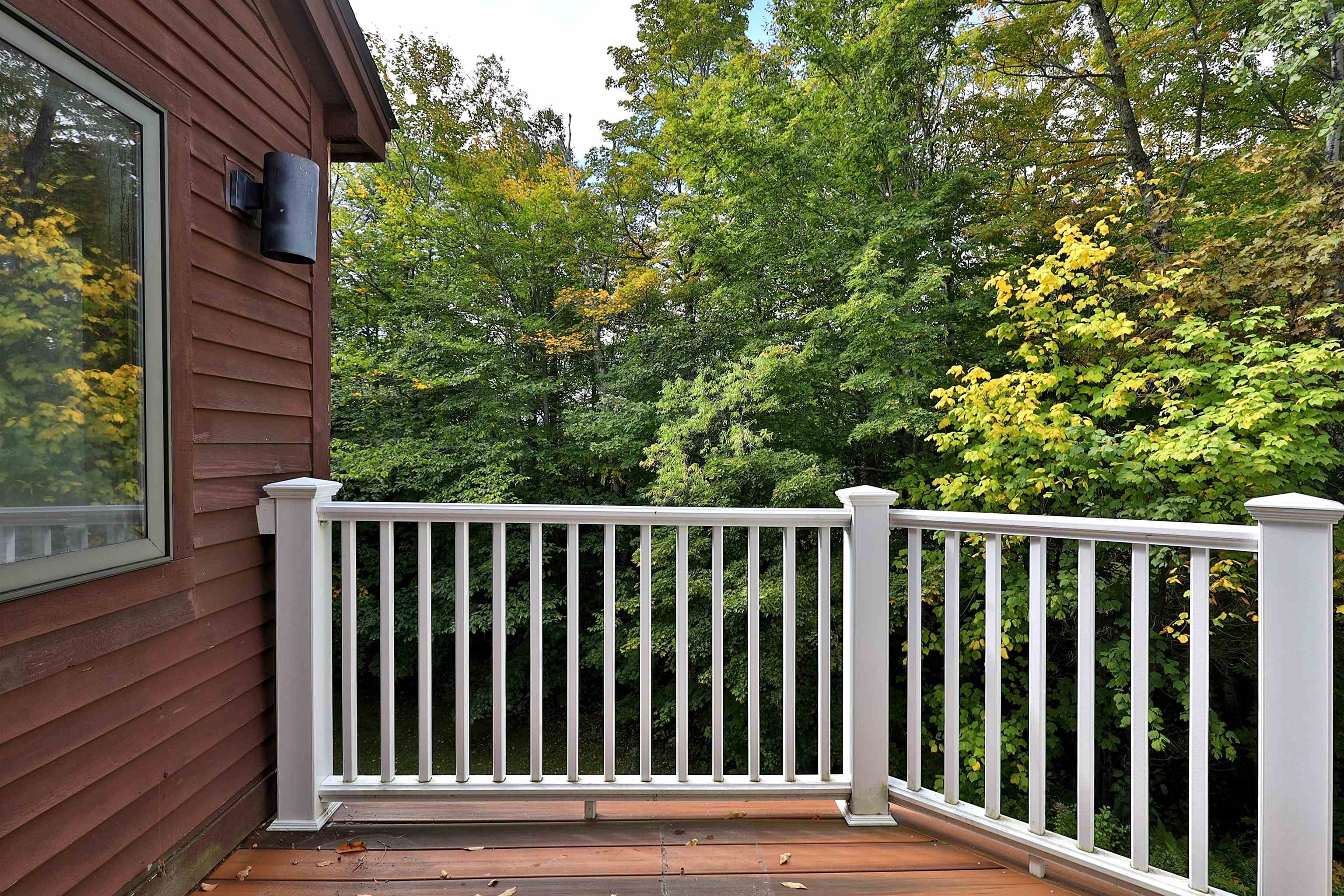 Exterior deck with updated flooring and railings 23618272