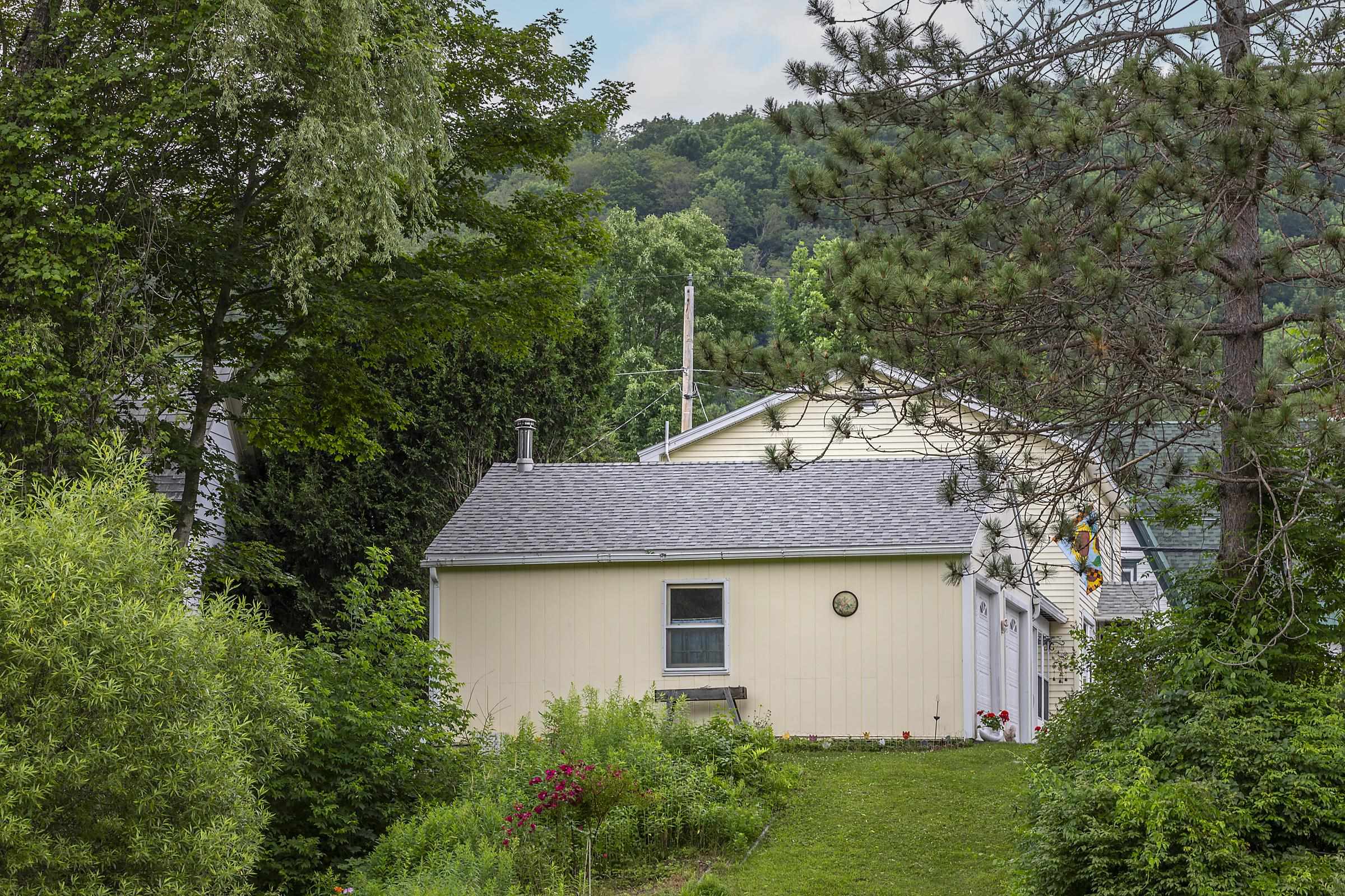 View from yard towards garage and house