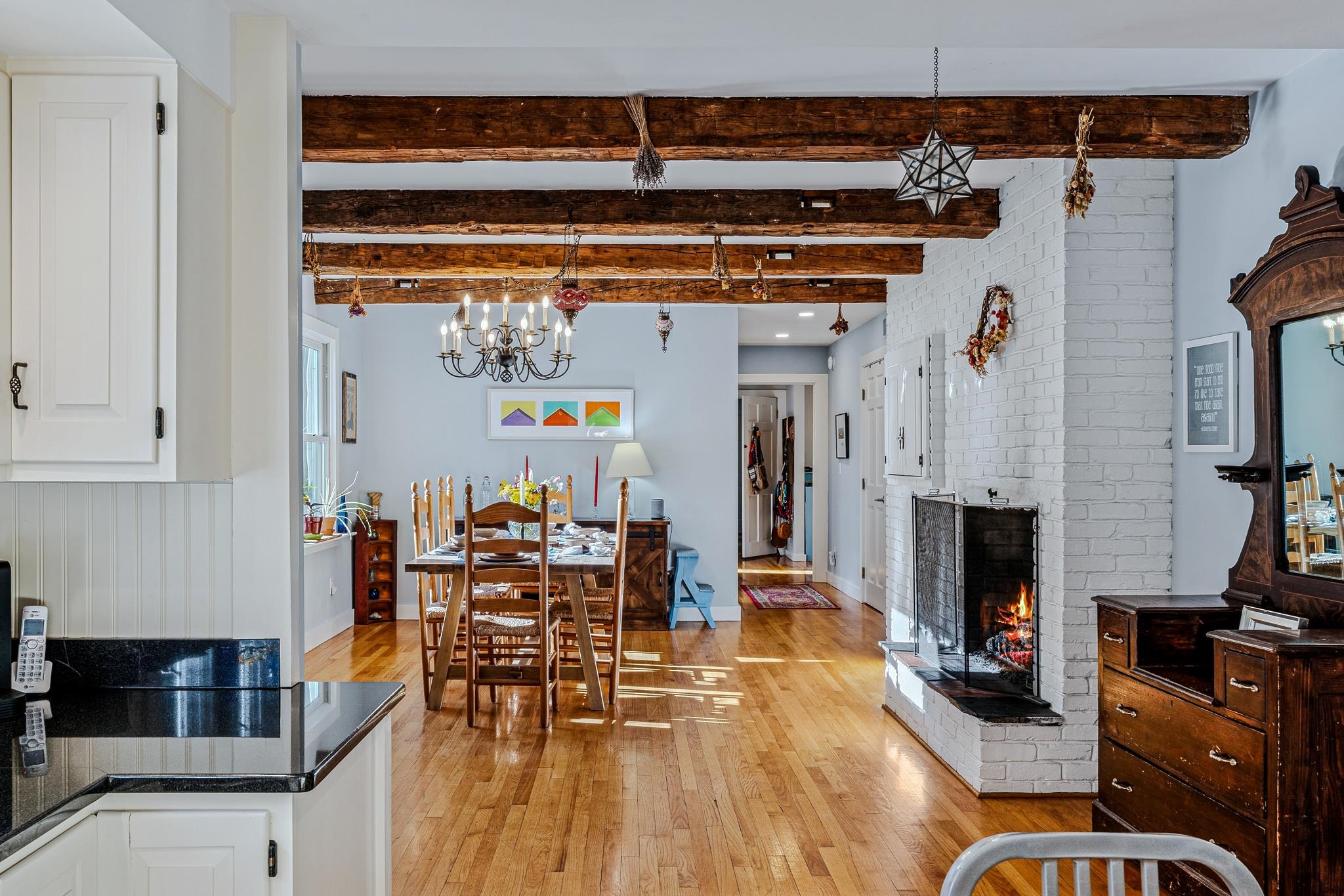 Kitchen Opens onto Dining Room with Fireplace