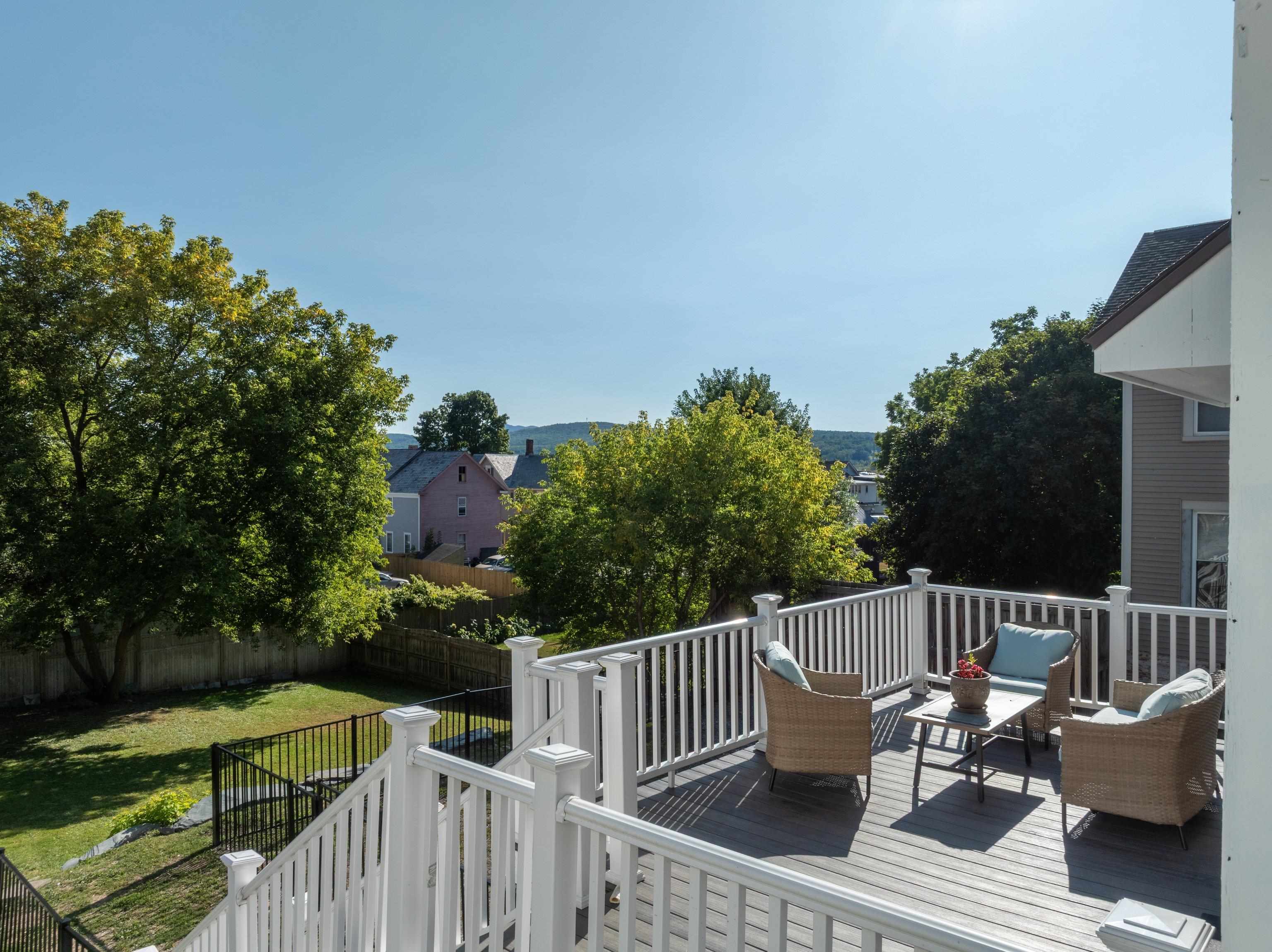 SUNNY BACK PORCH OVERLOOKING YARD