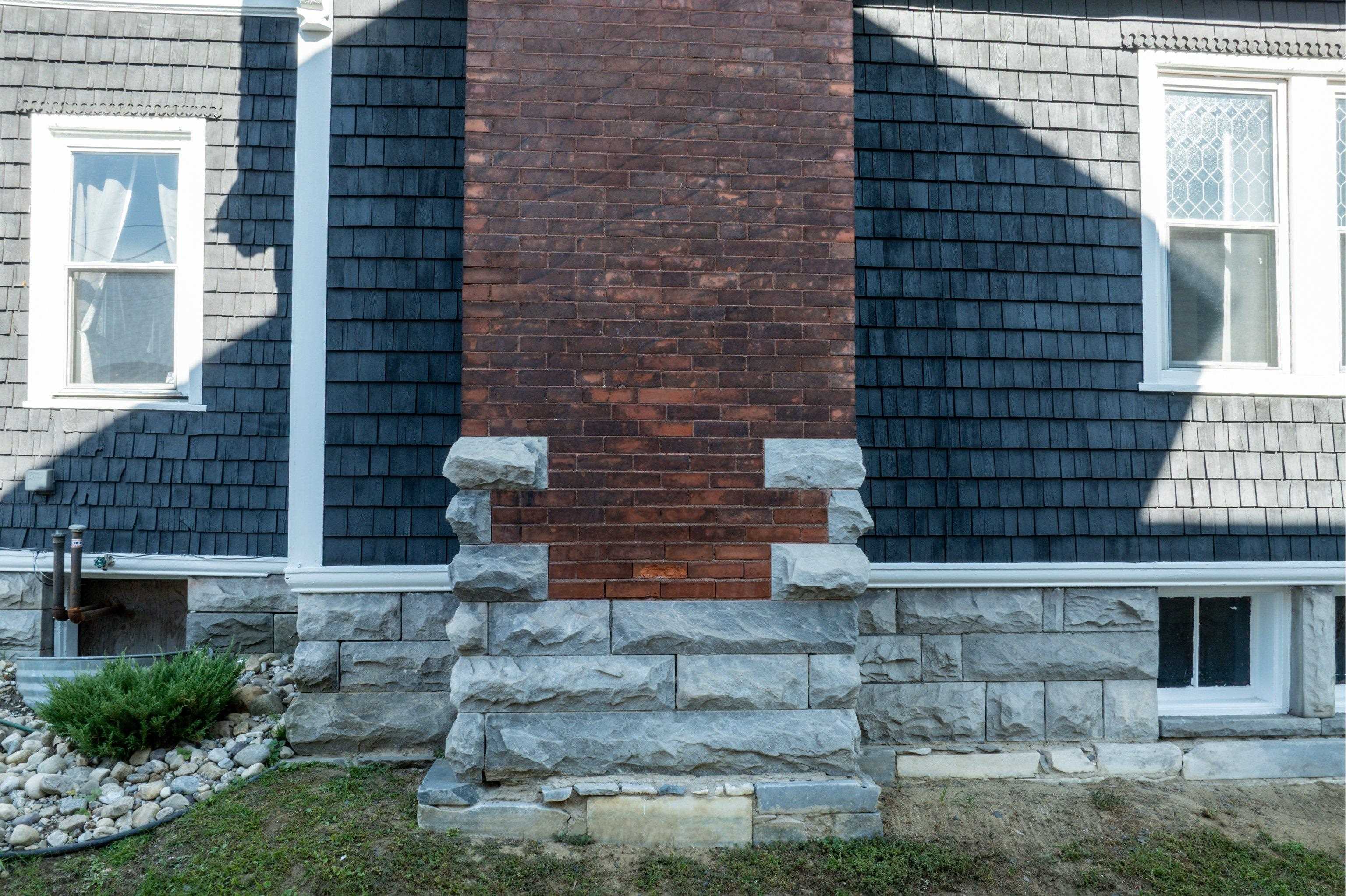 BEAUTIFULLY LAID BRICK FIREPLACE AND STONE