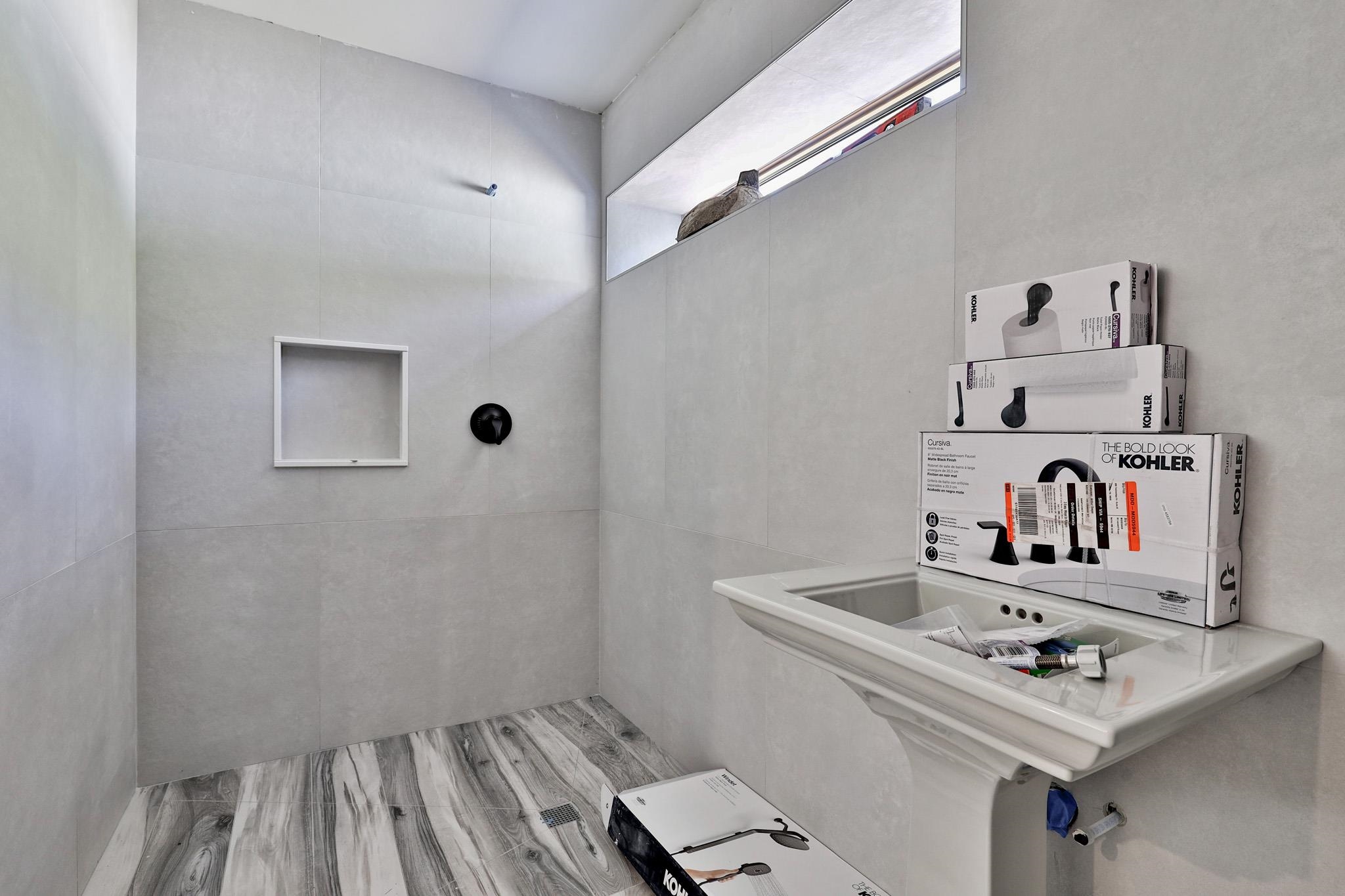 Lower level bathroom with tile shower 24147220
