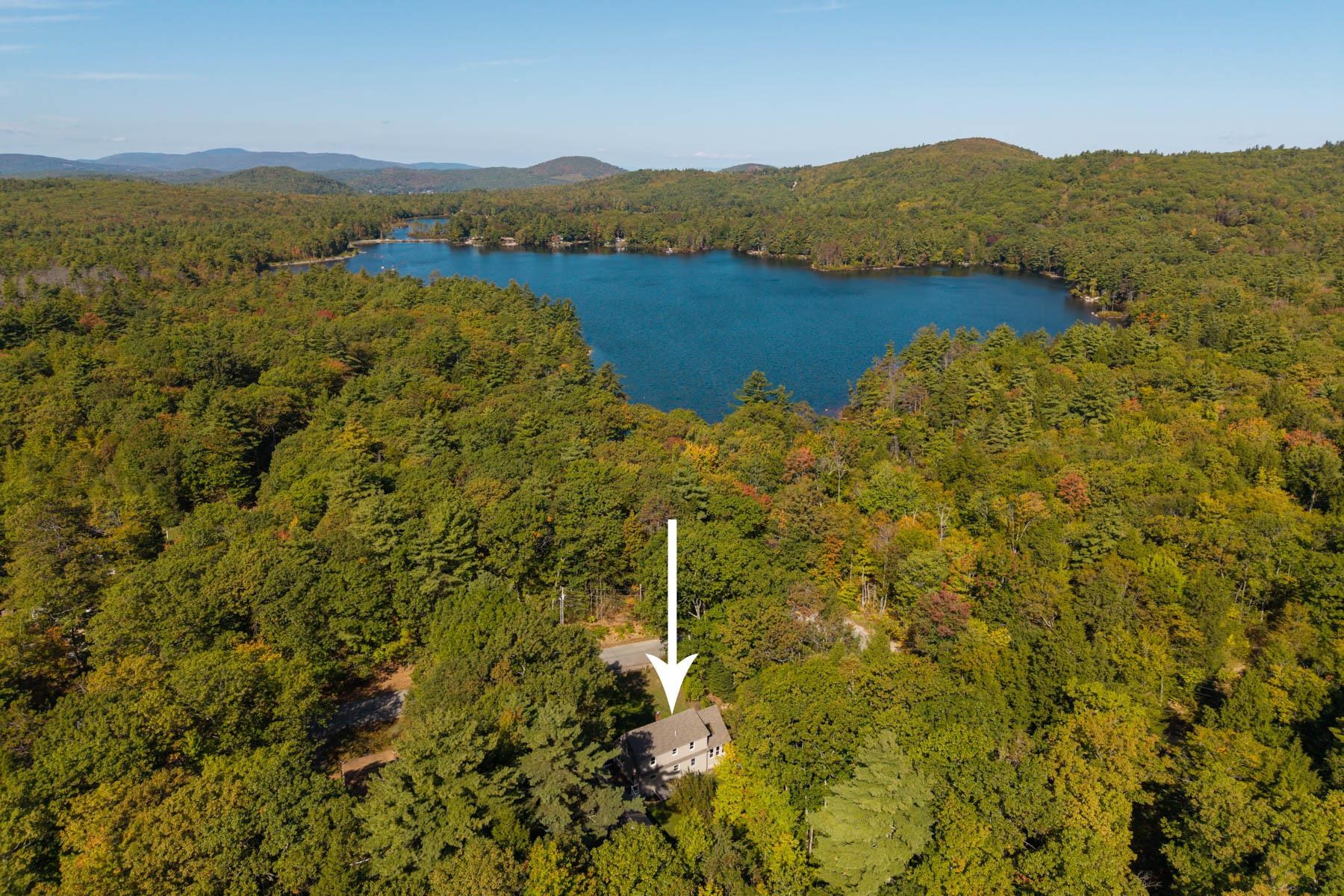 Will continue to show this EXTENSIVELY RENOVATED home offering 3 beds, 2.5 baths, and a large/detached 2-car garage. Perfectly situated across from scenic March’s Pond, the property blends New England charm with modern upgrades. Step inside to a stunning new kitchen featuring all new cabinetry, quartz counters, Samsung appliances, and a coffee bar—ideal for morning routines or entertaining. The dining room flows seamlessly into a welcoming living room with a cozy woodstove, creating the perfect space for gatherings. The first-floor primary suite is wrapped in windows and features a stunning vaulted ceiling clad in warm pine planks! The suite offers a brand-new bath with a spectacular custom tiled shower, double vanity and designer mirrors, lights and hardware, along with a large closet and laundry hookups! Upstairs you'll find two spacious bedrooms and a full bathroom.  The finished lower level adds flexible space for a rec room, home office or playroom, along with an additional laundry room and additional room for storage or further expansion. Additional highlights include a brand-new roof, new electric/plumbing, new flooring, Trex deck, freshly painted siding, new garage doors, and a brand- HVAC system with central air for year-round comfort! Enjoy access to March's Pond, while still being close to area lakes, trails, and commuter routes to the Seacoast, Lakes Region, and Concord. With its thoughtful renovations and prime location, this home is truly move-in ready.