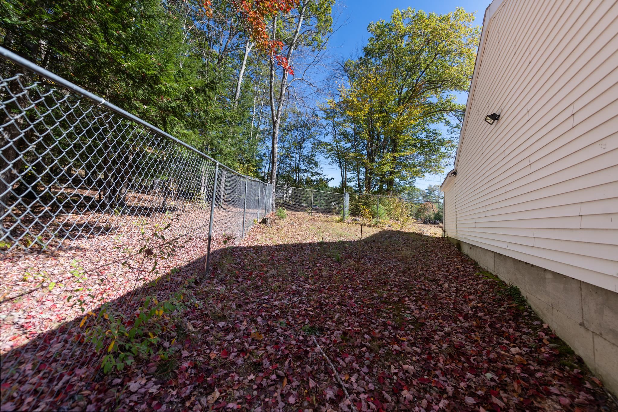 Chain link fence enclosure to the back & side of the home